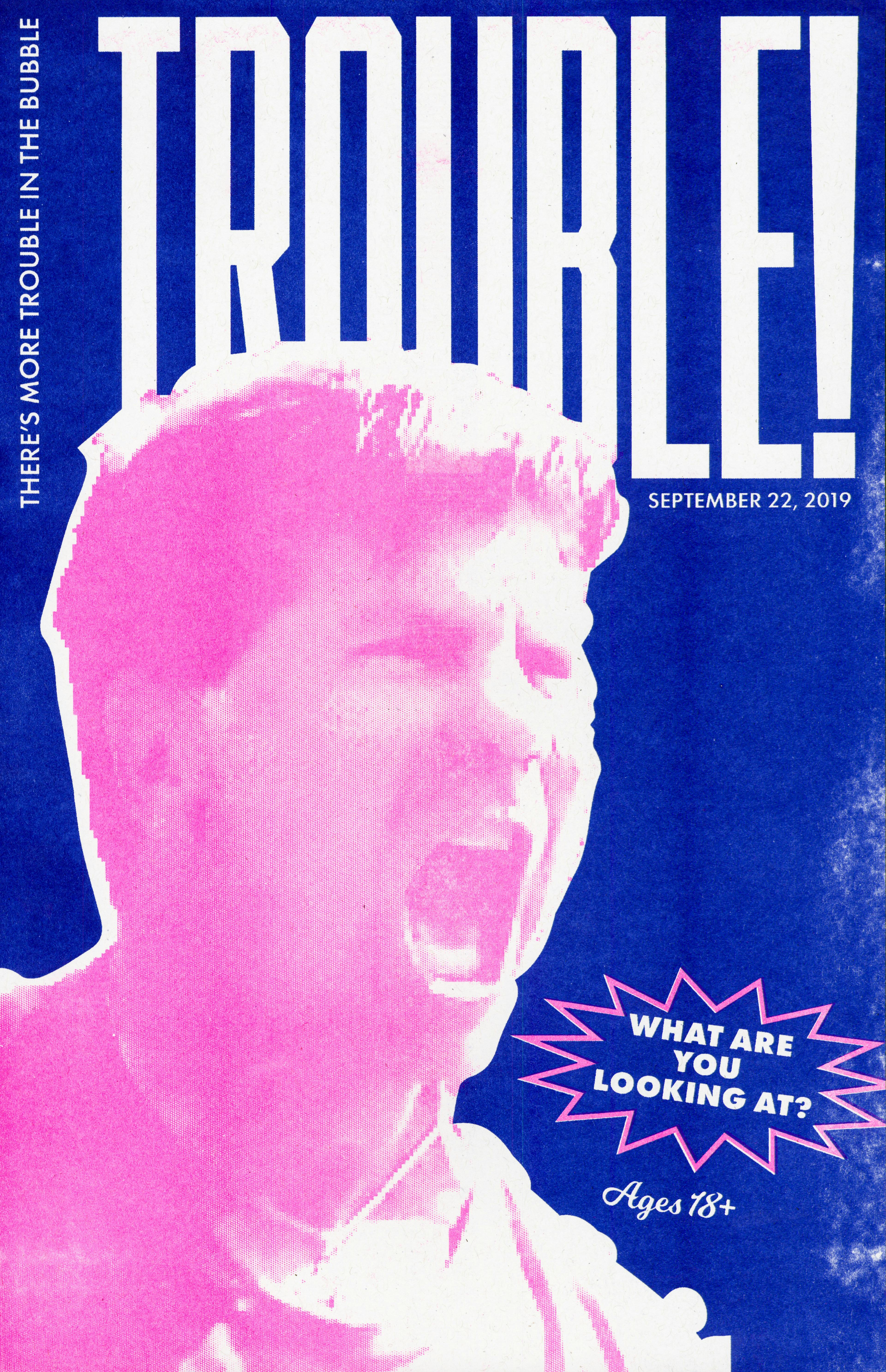 A blue poster with "Trouble" in big white letters with a pink closeup of Eric Furda shouting with smaller text saying "What are you looking at?"