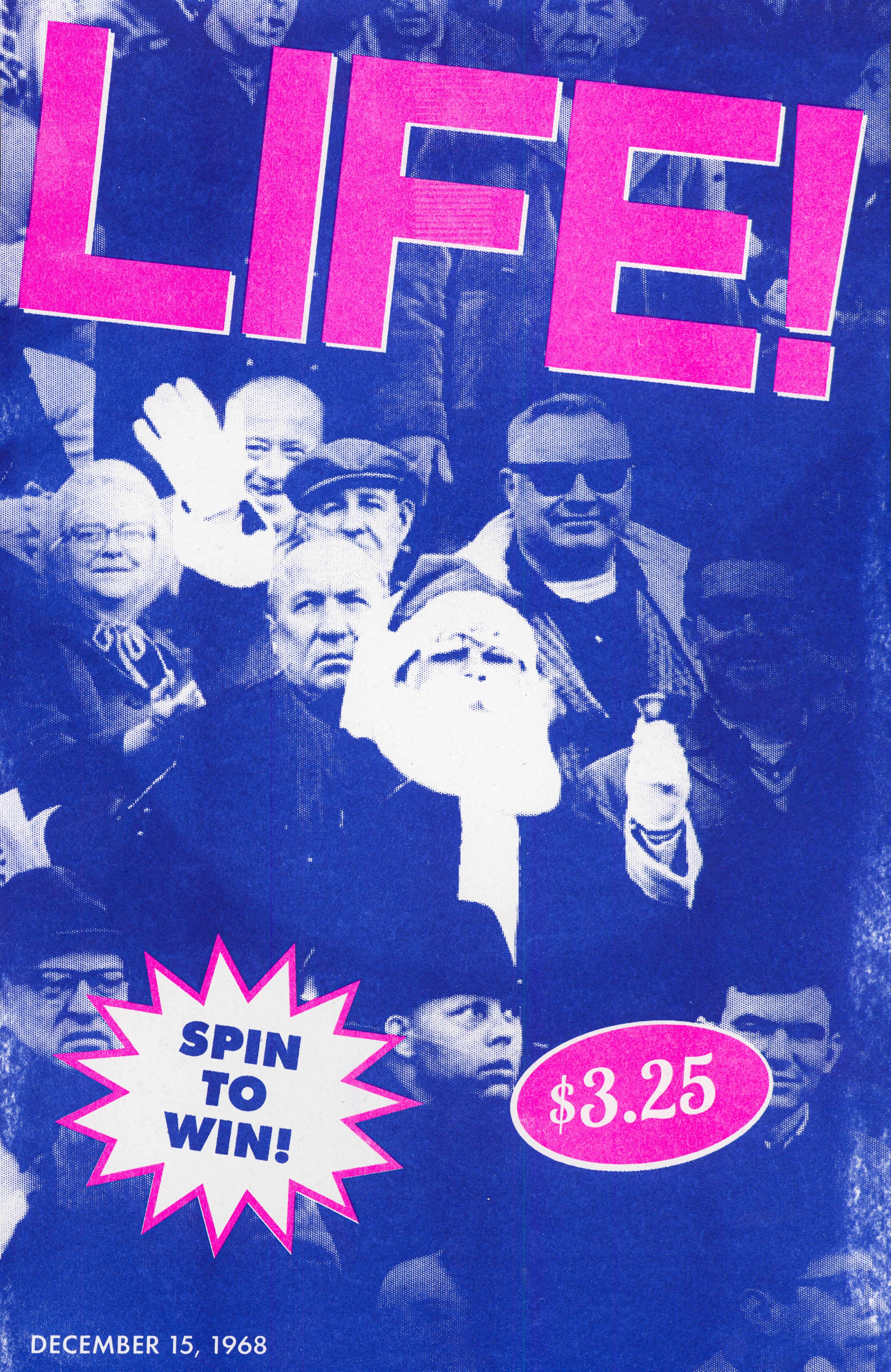 A blue poster with "LIFE" in big pink letters with a picture of Santa Claus