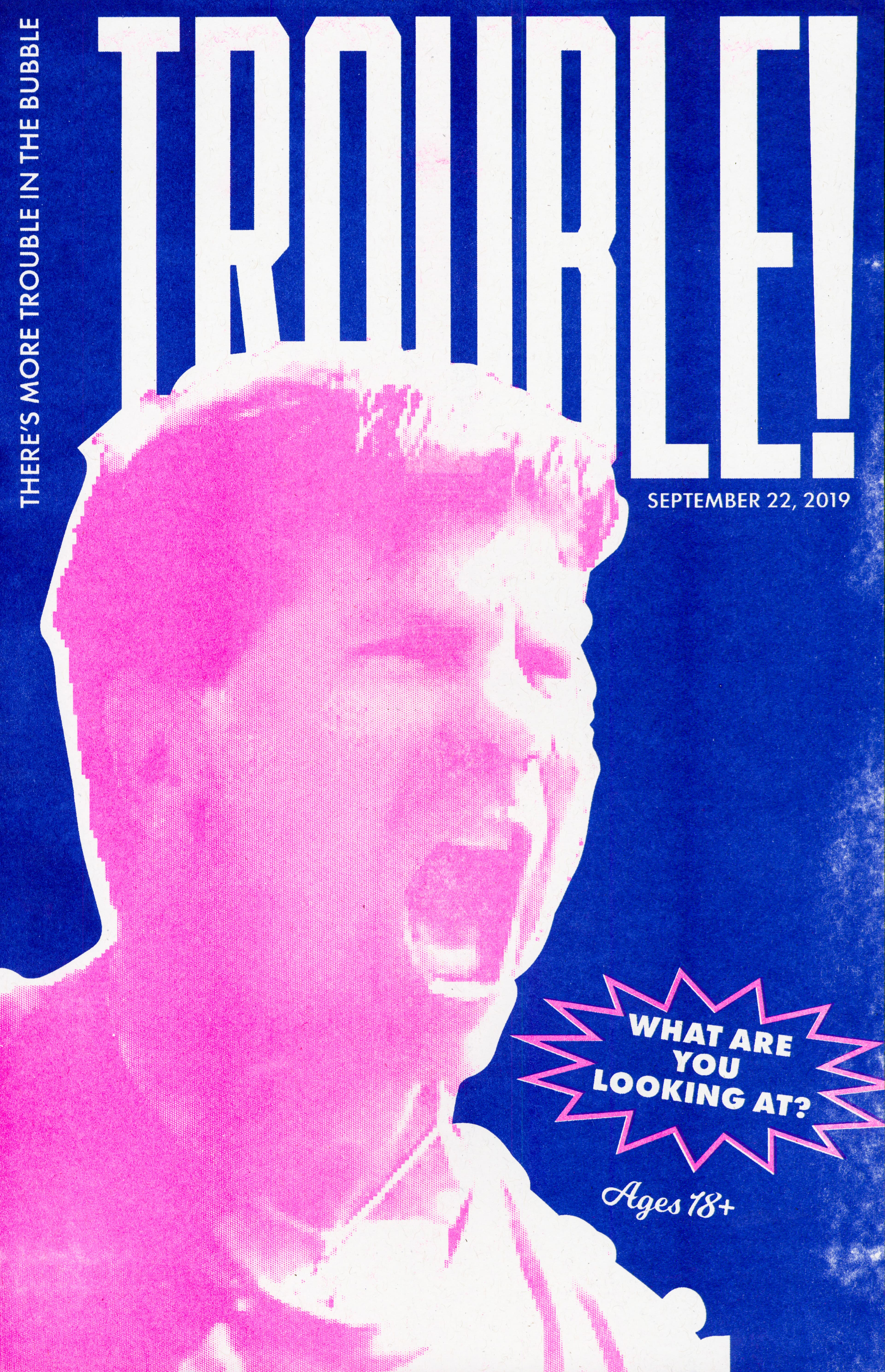 A blue poster with "Trouble" in big white letters with a pink closeup of Eric Furda shouting with smaller text saying "What are you looking at?"